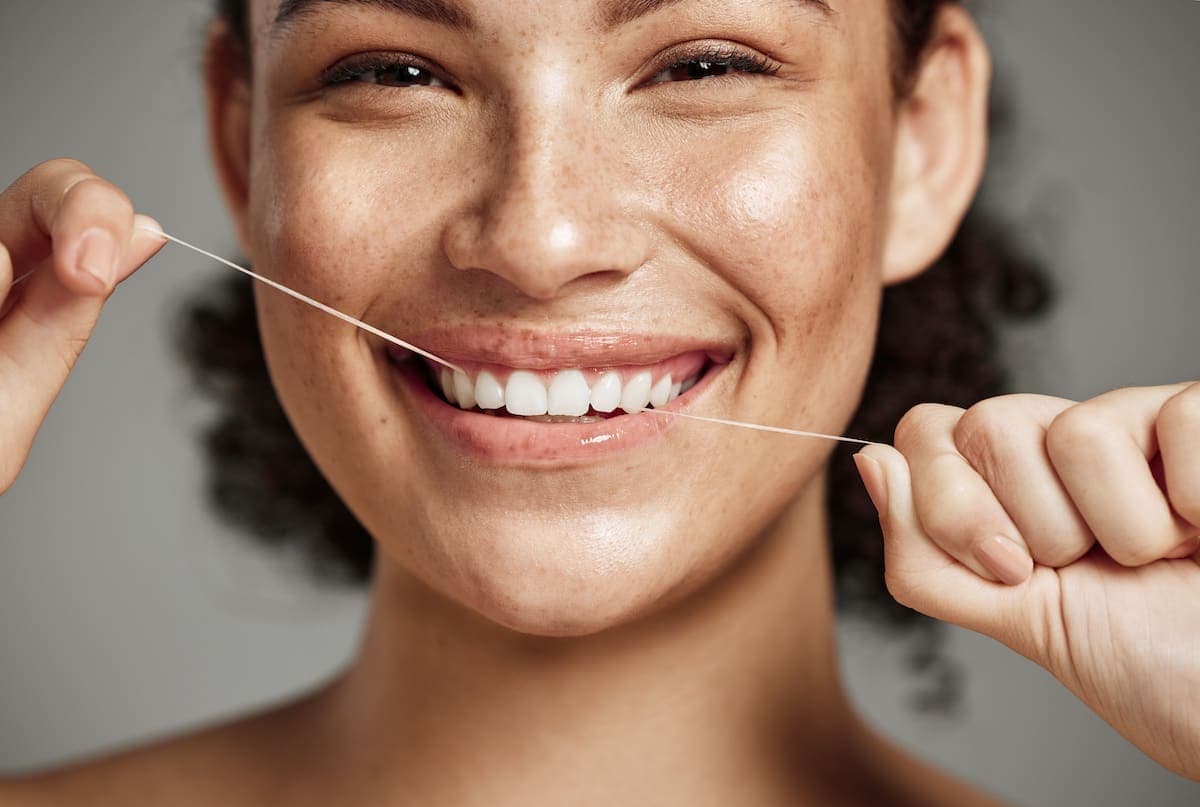 Dental floss and toothbrush on a bathroom counter