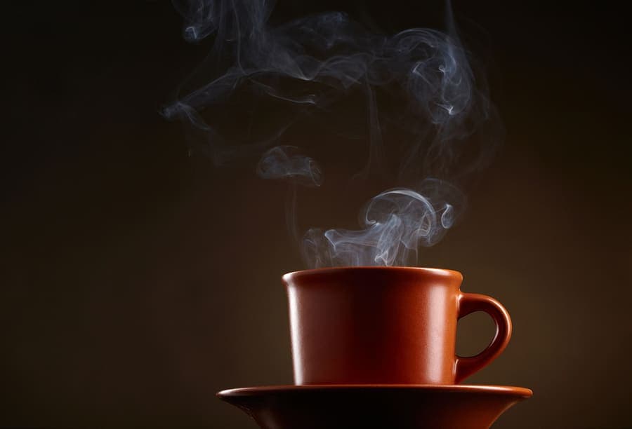 Person reacting after sipping a hot drink