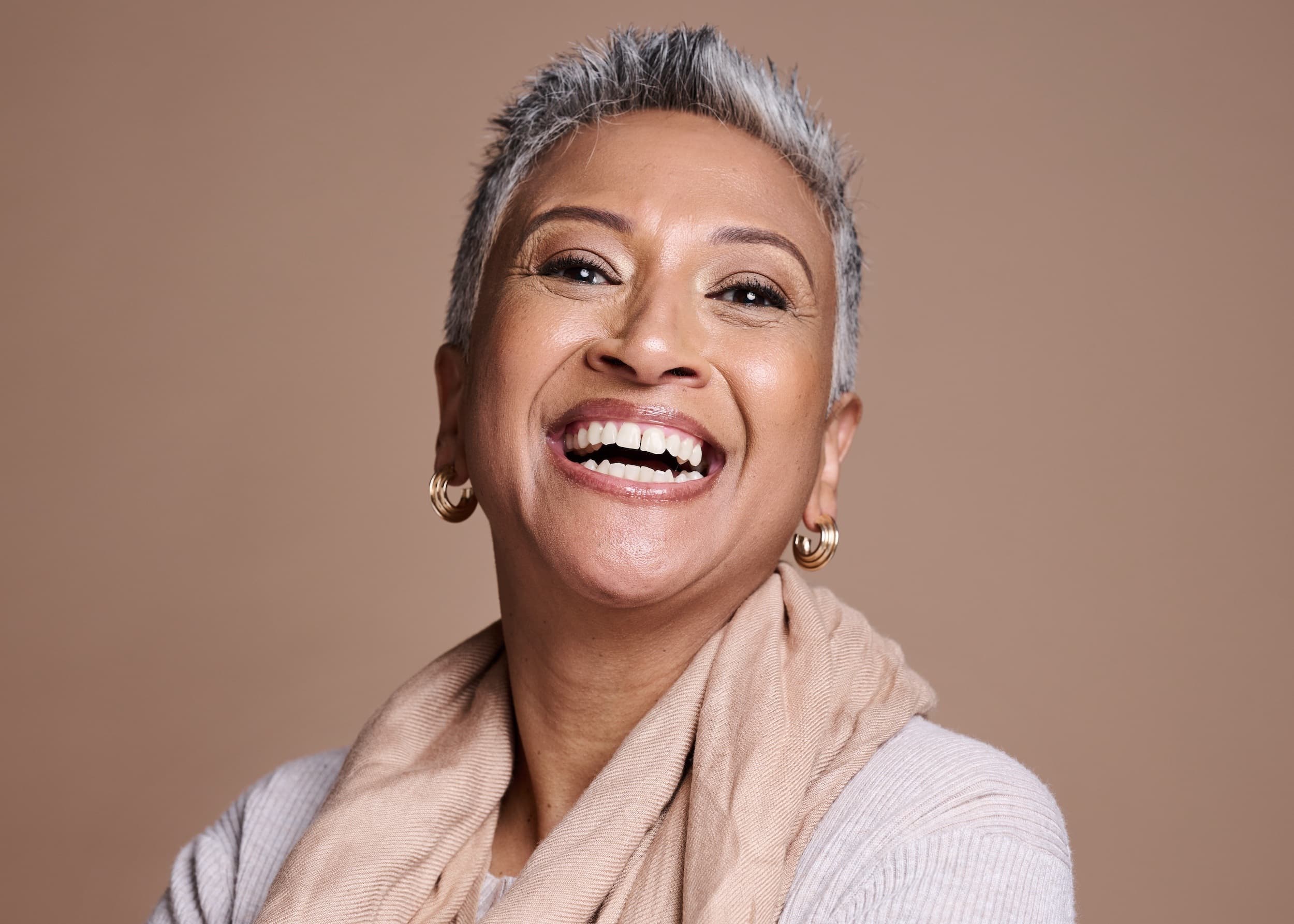 Confident mature woman laughing after cosmetic dentistry transformation at Advanced Dental Care Leesburg VA