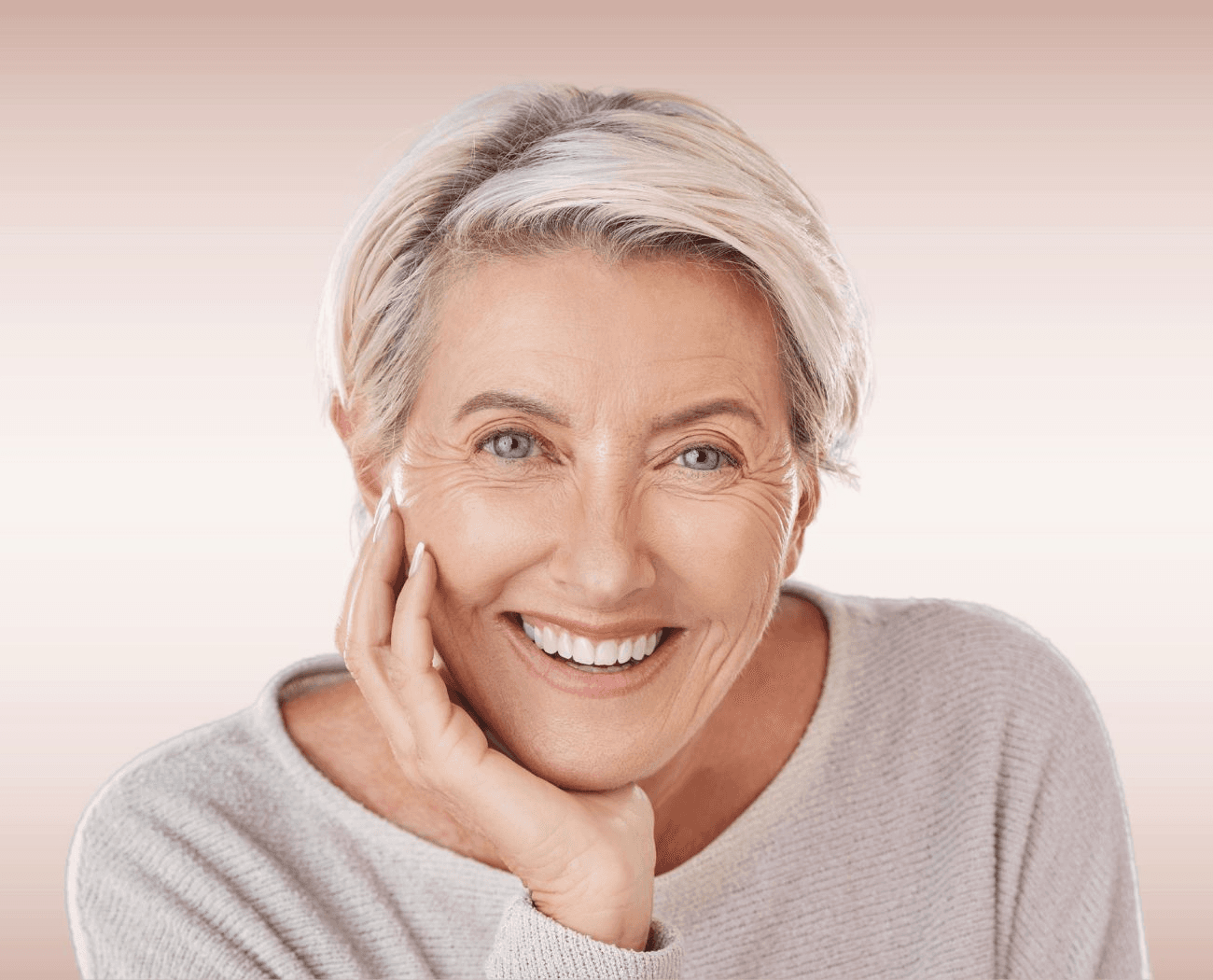 Elegant older woman smiling confidently with implant-supported dentures at Advanced Dental Care Leesburg