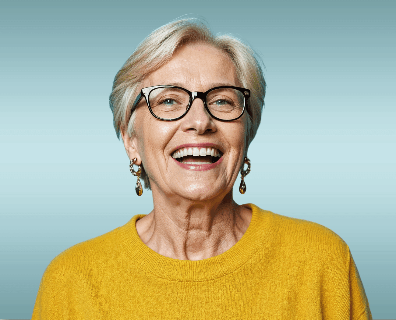 Mature woman with glasses laughing confidently after prosthodontic treatment at Advanced Dental Care Leesburg